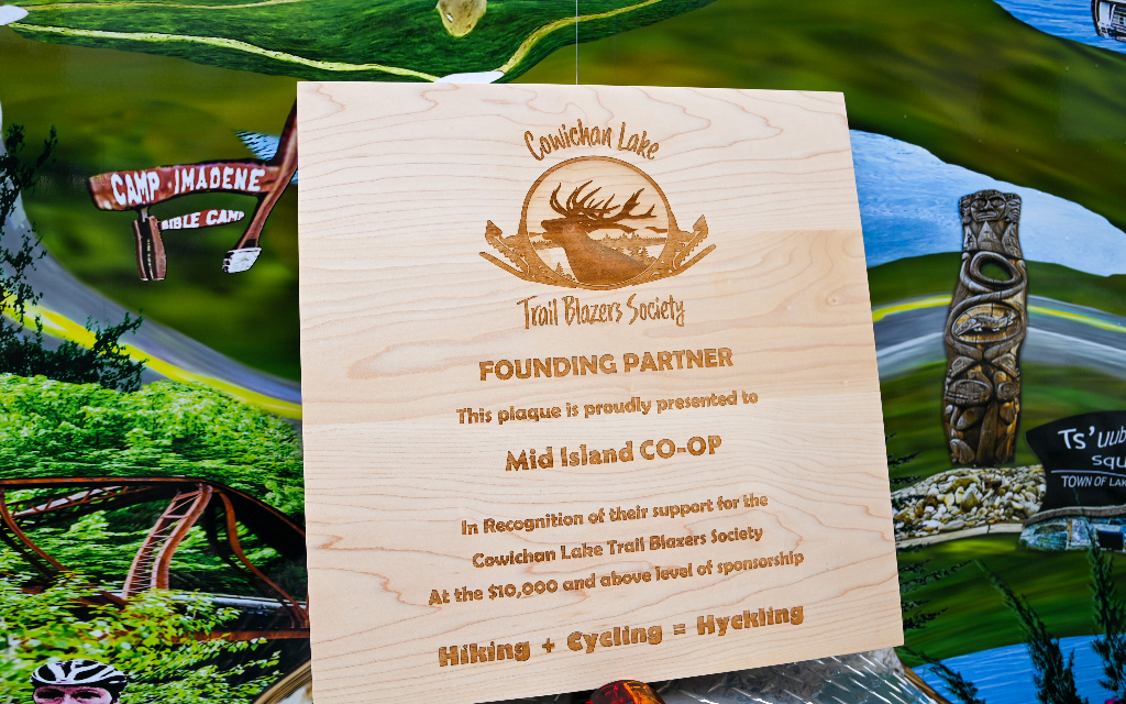 Cowichan Lake Trail Blazers Award Mid Island Co-op with a plaque of appreciation.