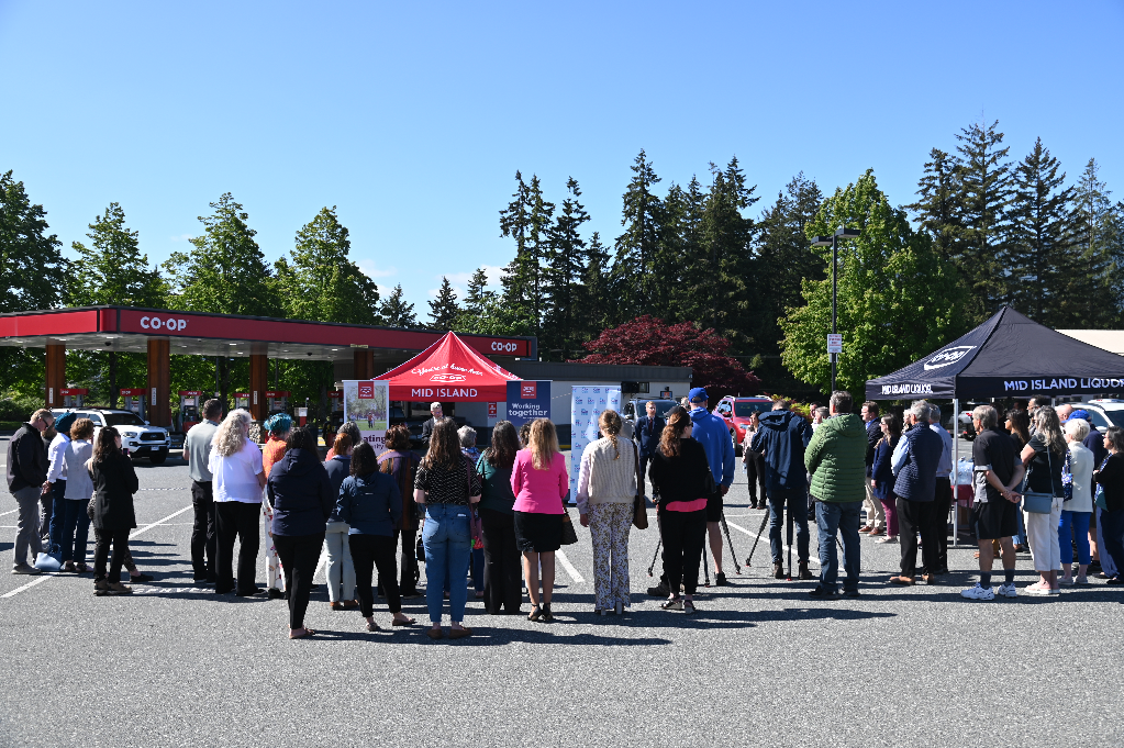 A crowd gathers at the Bowen Road Co-op to celebrate the announcement of Co-op's $1 million pledge