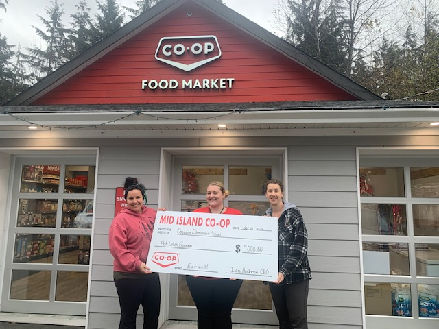 Sayward Elementary School PAC members accept a donation cheque from Mid Island Co-op