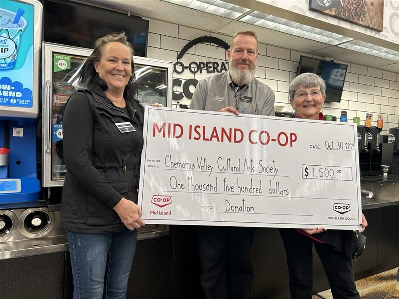 Chemainus Valley Cultural Arts Society accepts a donation cheque from Mid Island Co-op