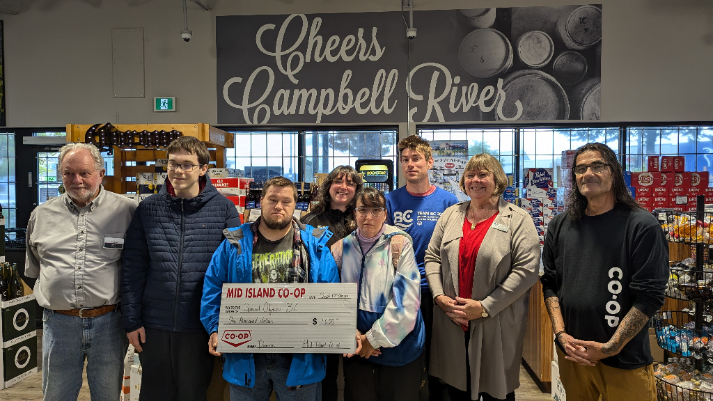 Special Olympics BC athletes accept a donation cheque from Mid Island Co-op