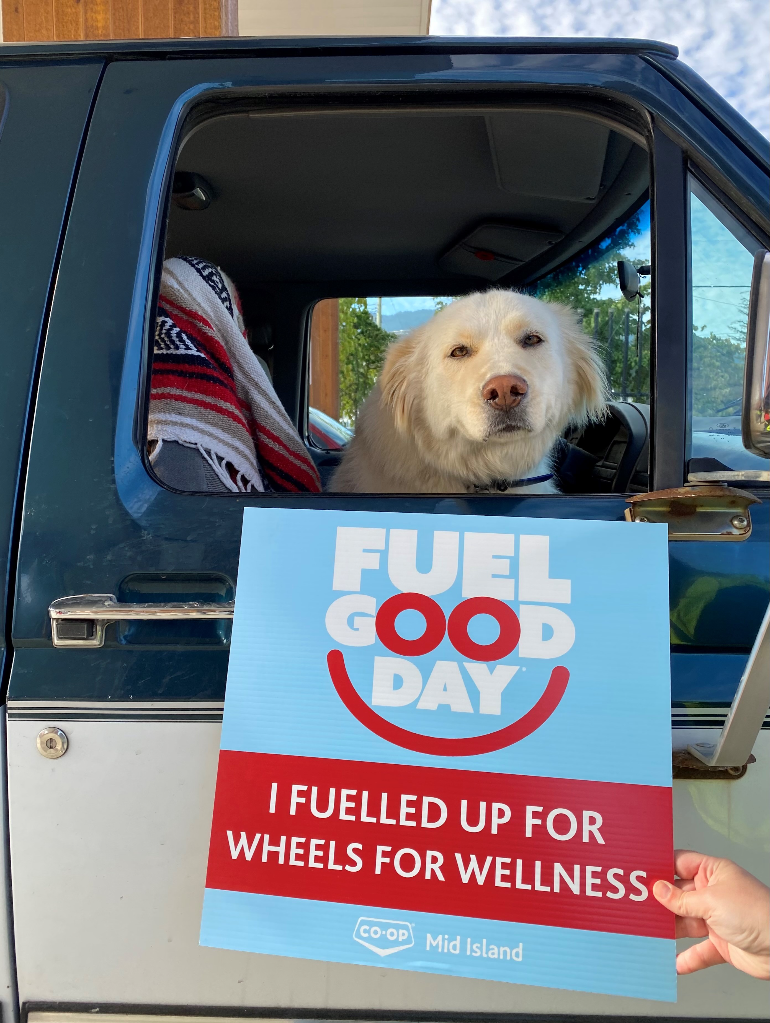 A dog with a Fuel Good Day sign