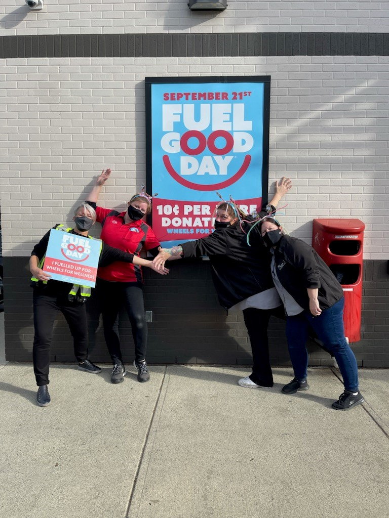 Co-op staff pose in from of a Fuel Good Day poster