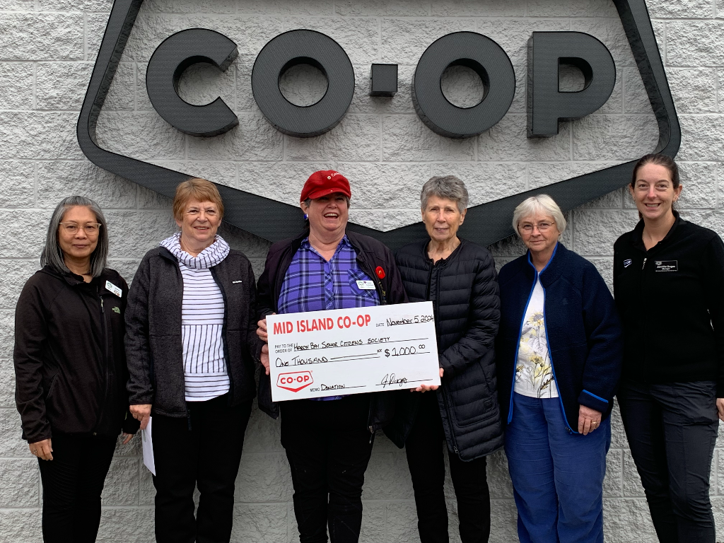 Hardy Bay Senior Citizens Society accepts a donation cheque from Mid Island Co-op